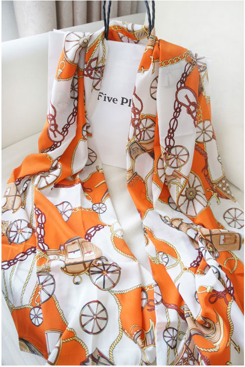 Scarf in orange with wheels pattern